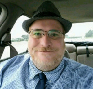 Thimble Insurance customer Jamie Vanagel in car for landscaping insurance