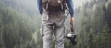 Adventurous travel photographer in forest for photographer insurance by Thimble