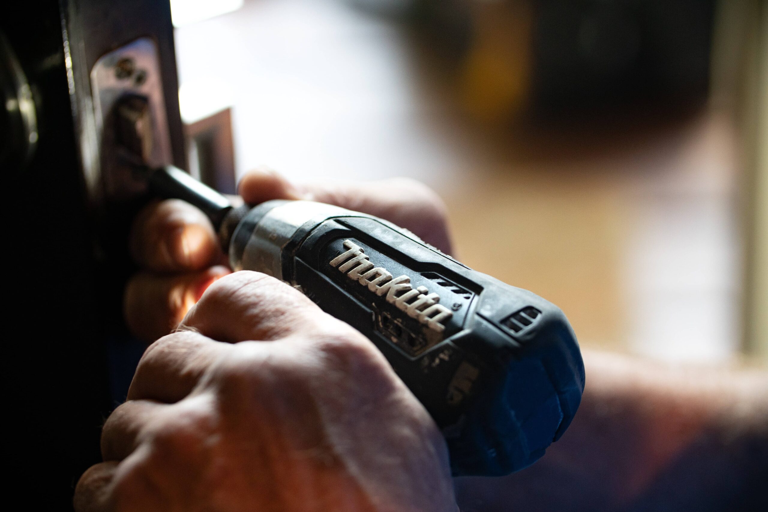 Handyman fixing the door lock