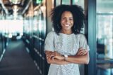 Smiling businesswoman with arms crossed