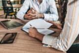 Business people negotiating a contract.