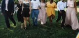 Group celebrating a wedding on a lawn